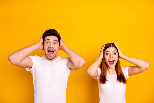 Close up photo two amazing beautiful she her he him his couple standing side by side oh yeah yes expression yelling unbelievable good news wear casual white t-shirts outfit isolated yellow background - Foto, Bild