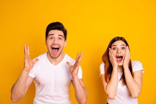 Close up photo amazing she her he him his couple hands arms raised air yell unbelievable luck lucky day cheerleader football match wear casual white t-shirts outfit isolated yellow background - Fotoğraf, Görsel