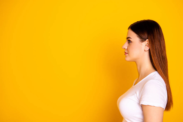 Close up side profile photo beautiful her she lady long straight perfect ideal hair look empty space not smiling attractive appearance wear casual simple white t-shirt isolated yellow background - Foto, immagini