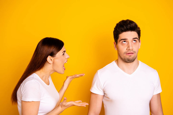 Close up side profile photo beautiful she her he him his guy lady pair blaming yell its your fault aggression awful situation round roll eyes up wear casual white t-shirts isolated yellow background - Foto, Imagen