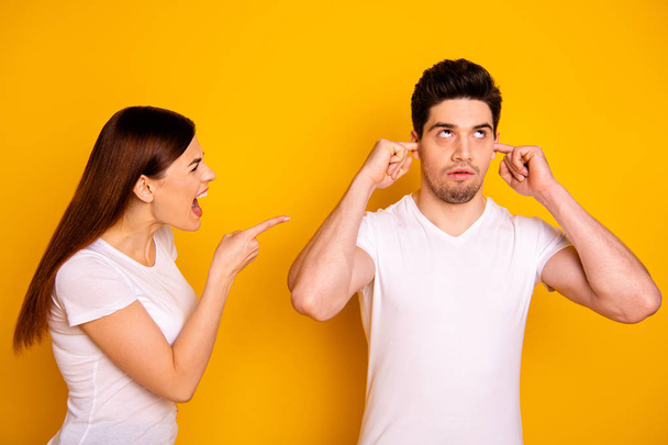 Close up side profile photo two beautiful people she her he him his blaming yell fault aggression awful roll eyes up hide ears fingers ignore wear casual white t-shirts isolated yellow background - Photo, Image