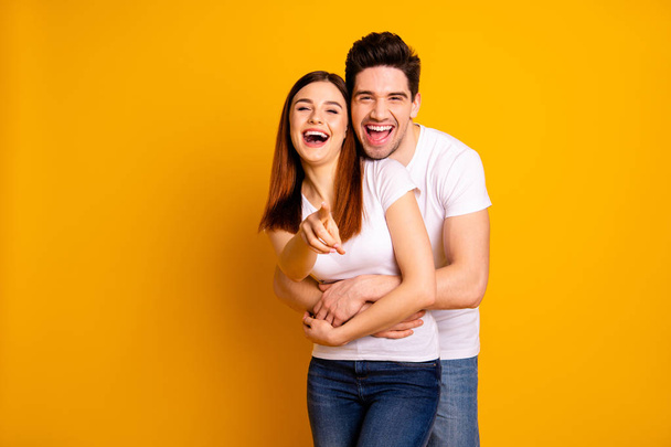 Portrait of his he her she two nice lovely attractive cheerful cheery positive people cuddling laughter pointing at you choose choice isolated over vivid shine bright yellow background - Fotoğraf, Görsel