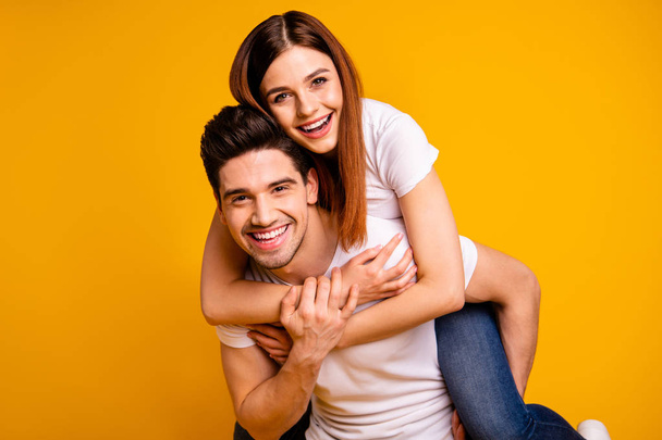 Close-up portrait of his he her she two nice attractive cheerful cheery optimistic people wife husband having fun spare free time isolated over vivid shine bright yellow background - Photo, Image