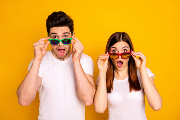 Portrait of his he her she two nice attractive lovely charming stylish trendy stunned people opened mouth isolated over vivid shine bright yellow background - Fotó, kép