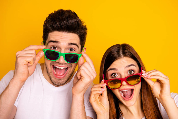 Close-up portrait of his he her she two nice attractive lovely charming stylish trendy cheerful cheery people opened mouth isolated over vivid shine bright yellow background - Foto, Imagen