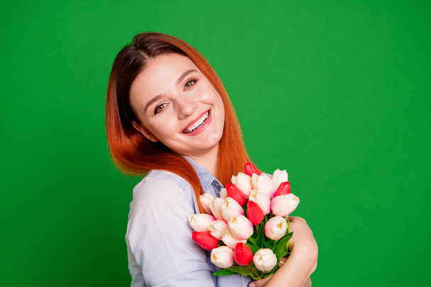 Close up side profile photo beautiful she her foxy lady celebrate holiday thankful hands arms hold flowers overjoyed emotional feelings wear casual jeans denim shirt isolated green bright background - Foto, Imagem