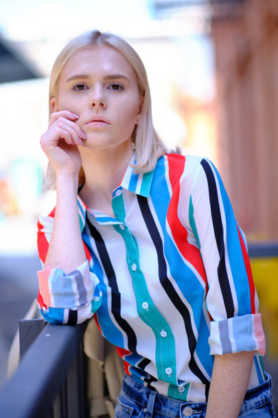 Fashionable girl in a summer shirt on the city street - Фото, зображення