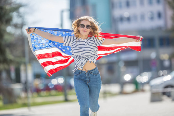 Attractive happy young girl with the flag of the United states o - Photo, Image