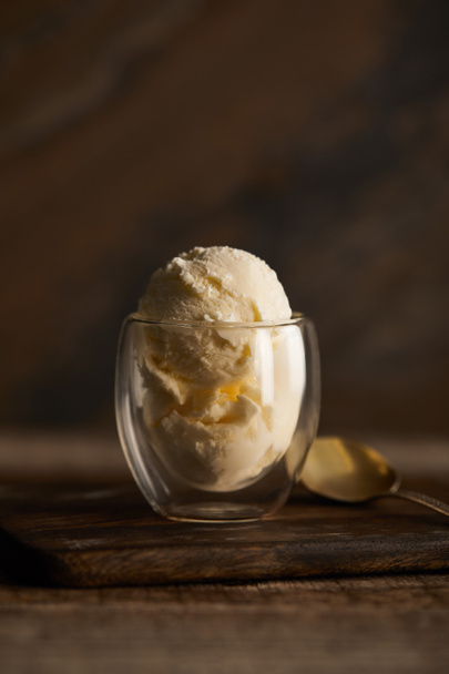 delicious ice cream scoop in glass with spoon on wooden table - 写真・画像
