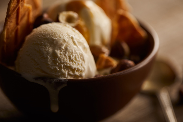 selective focus of of delicious melting ice cream in bowl with pieces of waffle  - Fotoğraf, Görsel