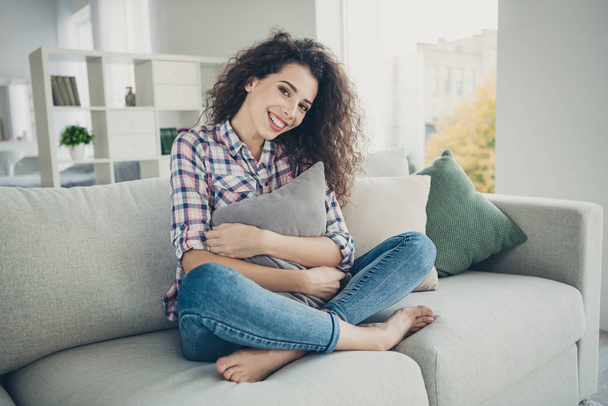 Portrait of lovely charming student millennial have vacation feel glad peaceful calm holidays stylish trendy sit divan lotus position legs folded crossed in living room - Foto, afbeelding