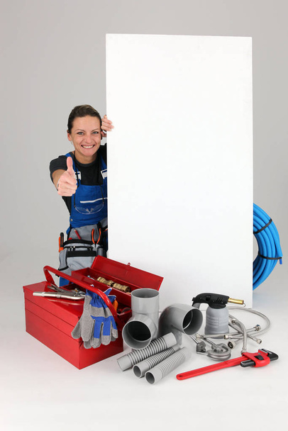 Joyful female laborer with panel and toolbox - Valokuva, kuva