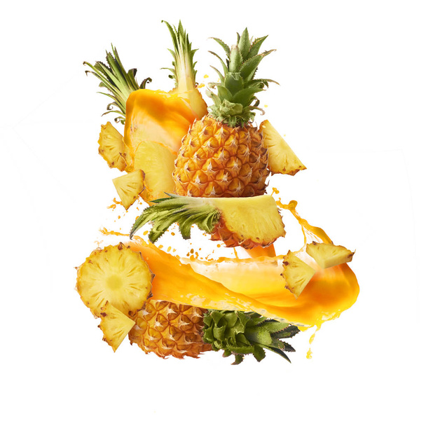 Flying in air fresh ripe whole and cut baby Pineapple with slice - 写真・画像