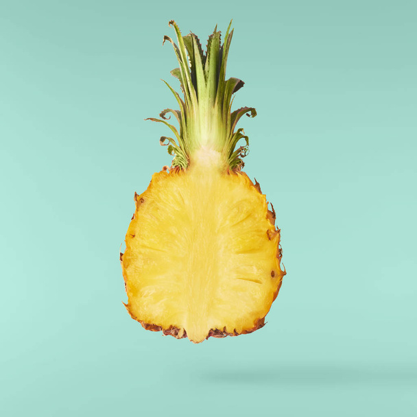 Flying in air fresh ripe whole and cut baby Pineapple with slice - Foto, Imagen