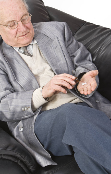 Close-up image of a senior man taking his medication. - Foto, immagini