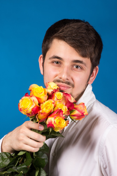 Man with bouquet of red roses - Photo, image