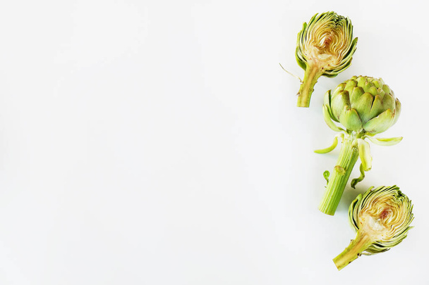 Fresh green Italian Artichoke isolated on white background. Organic local produce vegetable. Vegan diet. Clean eating concept. Close up, top view, flat lay. - 写真・画像