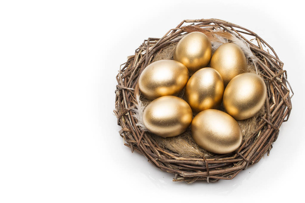 Nest with golden eggs on a white background. Golden Eggs in Nest - Fotó, kép