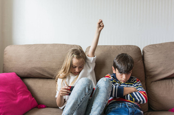 Children happily playing video games. - Foto, afbeelding