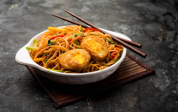 Egg Schezwan/hakka noodles, popular indochinese food served in a bowl with chopsticks. selective focus - Photo, Image