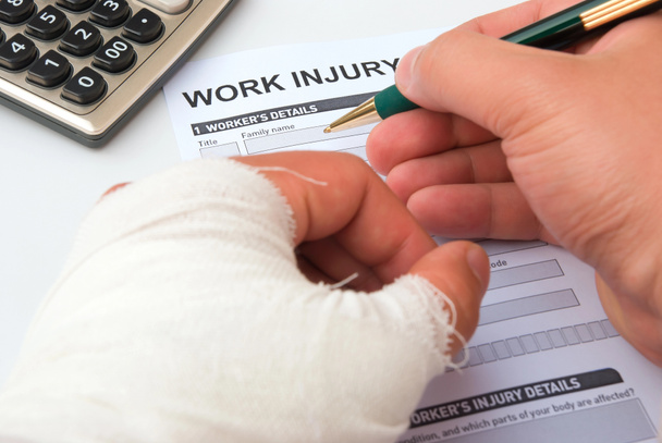 Filling up a work injury claim form - Photo, Image