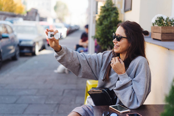 Cute, young female blogger posing on camera. - Valokuva, kuva