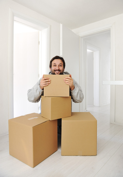 Man with boxes moving in new house - Photo, Image