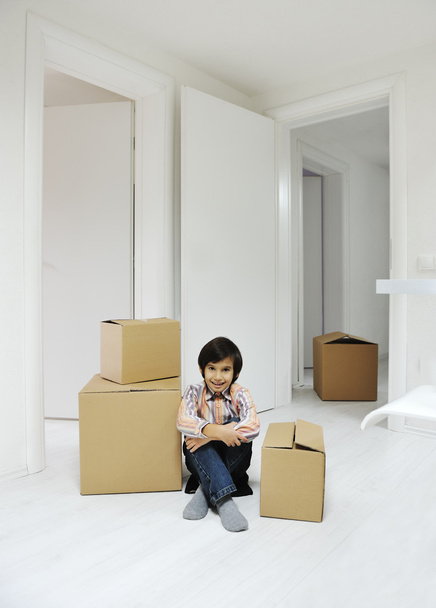 Little boy with moving boxes at new home - Fotografie, Obrázek