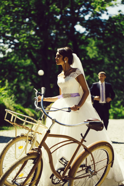 Beautiful bride with bicycles - Zdjęcie, obraz