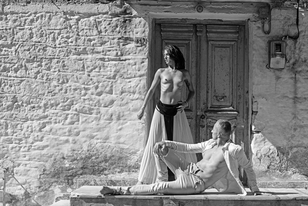Sexy woman and man have sex game. sexy woman with muscular man at door of stony house wall in sunny summer outdoor. - Fotó, kép