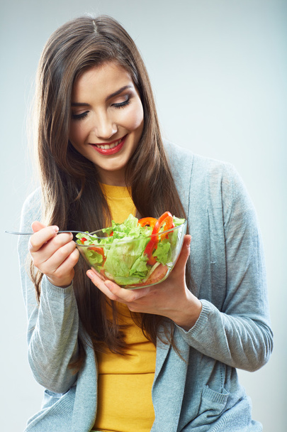 Young woman eating salad isolated - Фото, изображение