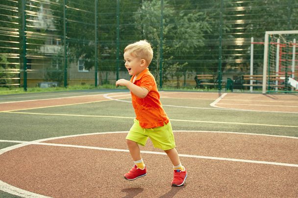 active little boy playing on playground in summer - Foto, Bild