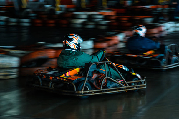 Competição de karting dinâmica em velocidade com movimento desfocado em uma pista de corrida equipada
 - Foto, Imagem