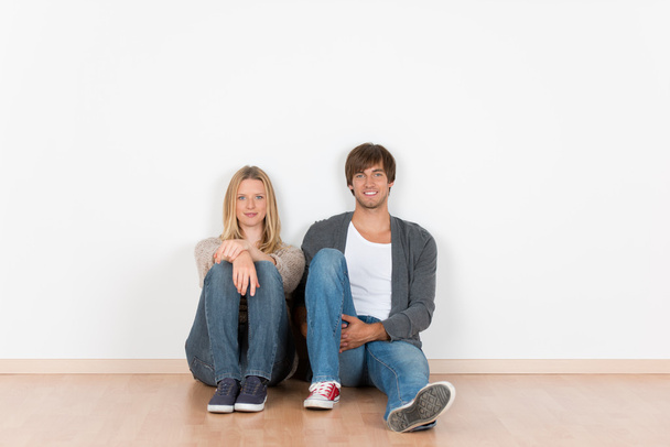 young couple sitting on the floor - Photo, Image