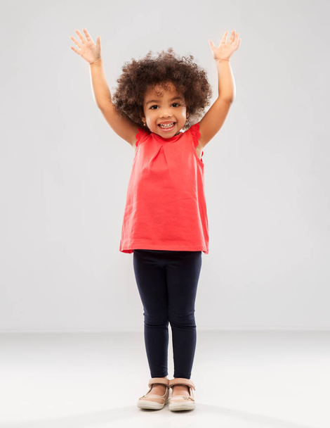 happy little african american girl with hands up - Zdjęcie, obraz