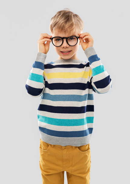 smiling boy in glasses and striped pullover - Zdjęcie, obraz