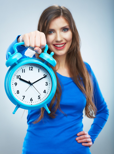 Young smiling woman in blue hold watch. Beautiful smiling girl - Foto, imagen