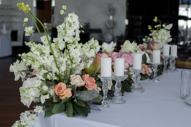 vastanaineet pöytä ravintola koristelu tuoreita kukkia ja kynttilöitä. Häät tuoreita kukkia koristelu
 - Valokuva, kuva