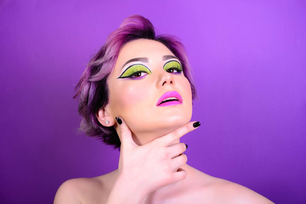 Sexy girl with short hair. Portrait of a woman with bright colored hair, all shades of purple. Beautiful lips and makeup. Professional coloring. professional makeup. - Valokuva, kuva