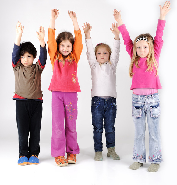 Grupo de quatro crianças com braços para cima
 - Foto, Imagem