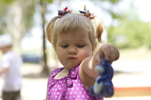 Adorable little girl having fun on a playground - Fotografie, Obrázek