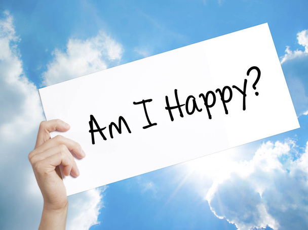 Am I Happy? Sign on white paper. Man Hand Holding Paper with text. Isolated on sky background.  Business concept. Stock Photo - Фото, зображення