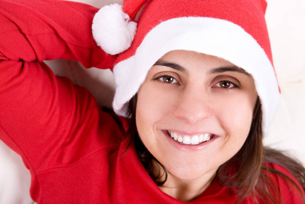 beautiful young woman with red christmas hat portrait - Photo, image