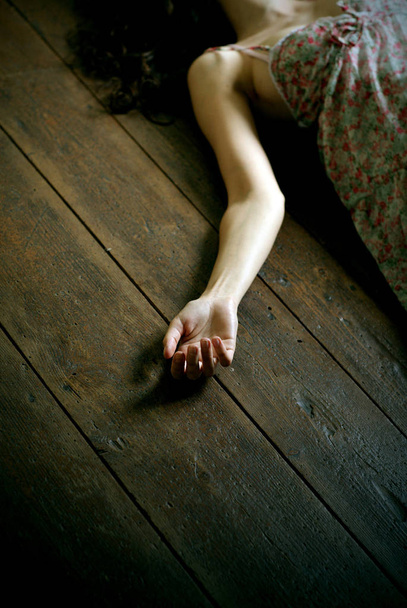 dead woman lying on the floor, focus on the hand - Foto, imagen