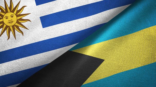 Uruguay en Bahama's twee vlaggen textiel doek, weefsel textuur  - Foto, afbeelding
