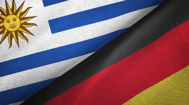 Uruguai e Alemanha duas bandeiras de pano têxtil, textura de tecido
 - Foto, Imagem