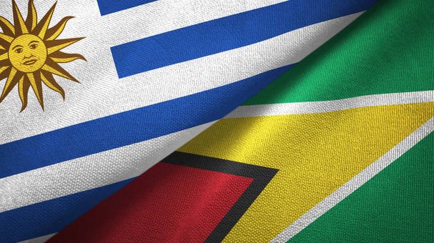 Uruguay a Guyana dvě vlajky textilní tkaniny, textura tkaniny - Fotografie, Obrázek