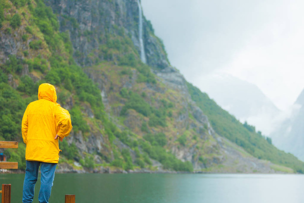 Tourist loking at mountains and fjord Norway, Scandinavia. - 写真・画像