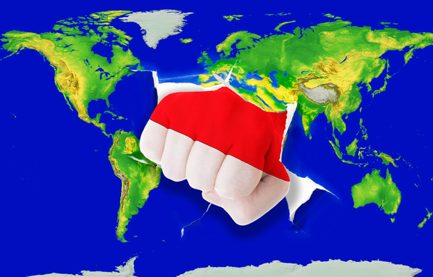 pięść w kolor flagi narodowej z Indonezji nabijania mapa świata - Zdjęcie, obraz