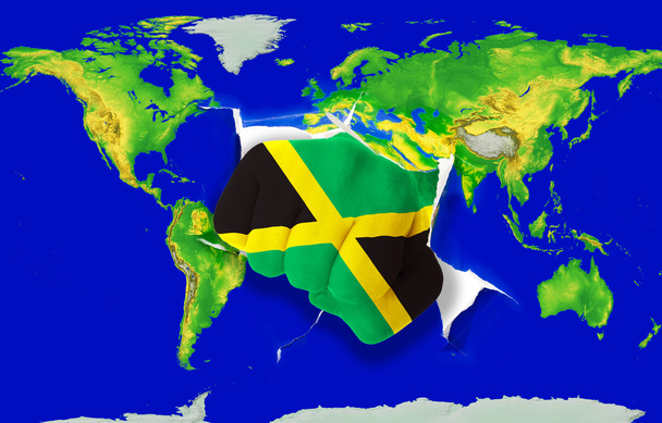 γροθιά στο χρώμα εθνική σημαία της Τζαμάικα διάτρησης παγκόσμιο χάρτη - Φωτογραφία, εικόνα